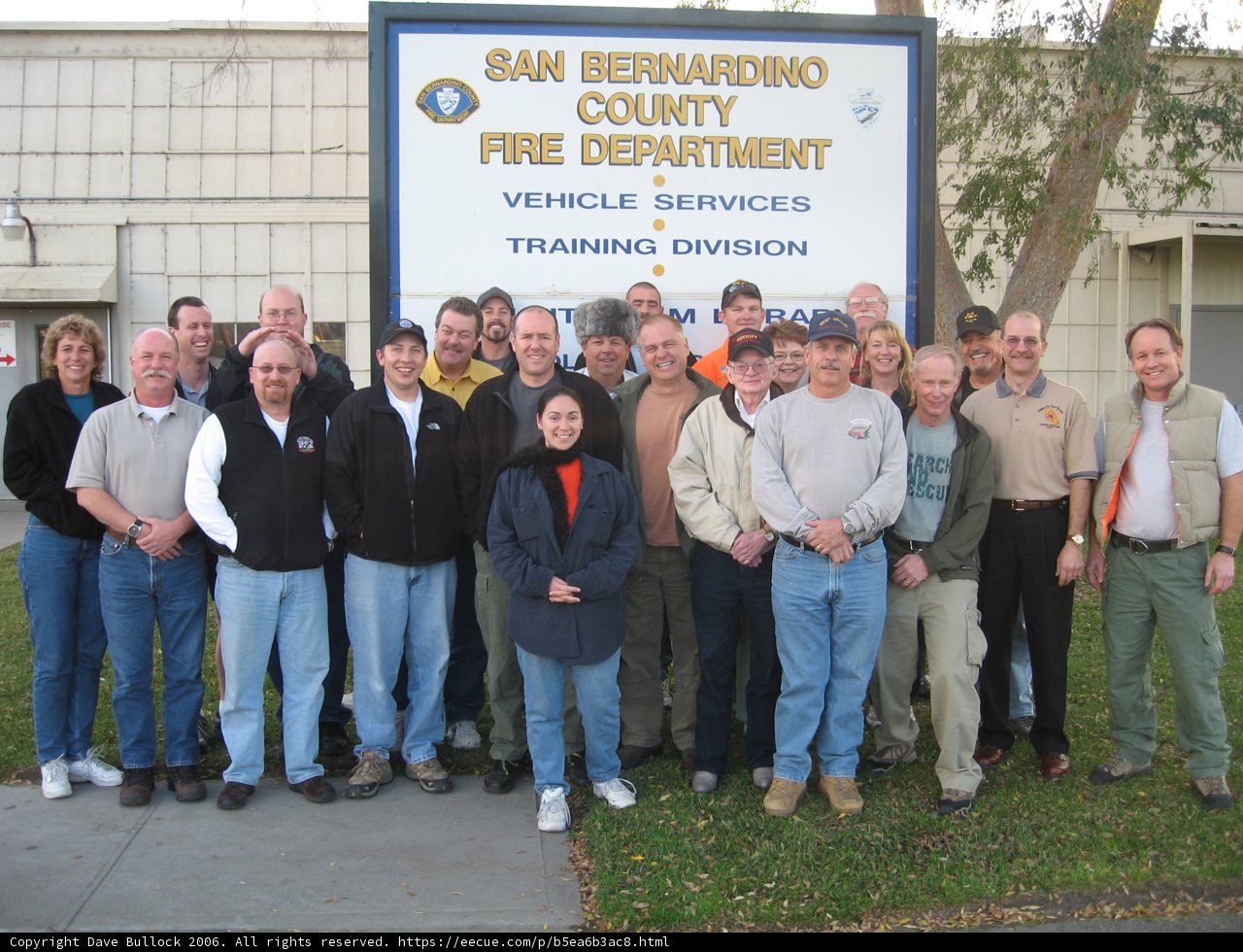 Group of 21 People posing in front of Architecture Building