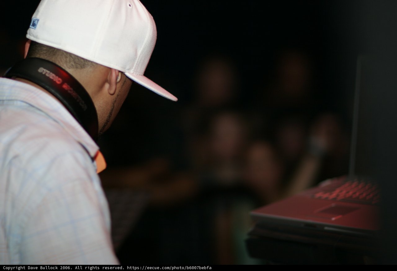 Man Wearing a Hat and Using a Laptop