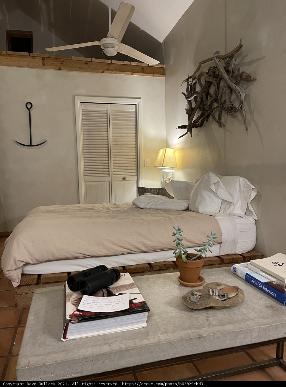 White Bed and Fan in a Cozy Bedroom