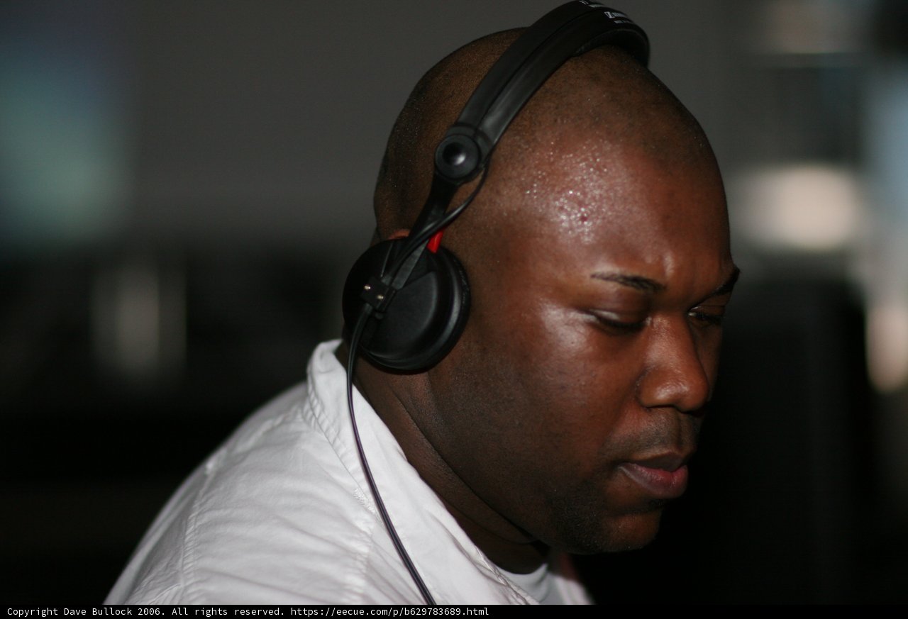 Grooving to the Beat Caption: This man is lost in the music, enjoying his headphones to the fullest.