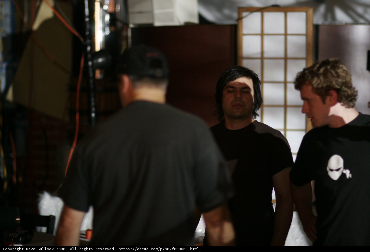 Three Men in T-shirts Strike a Pose in a Factory