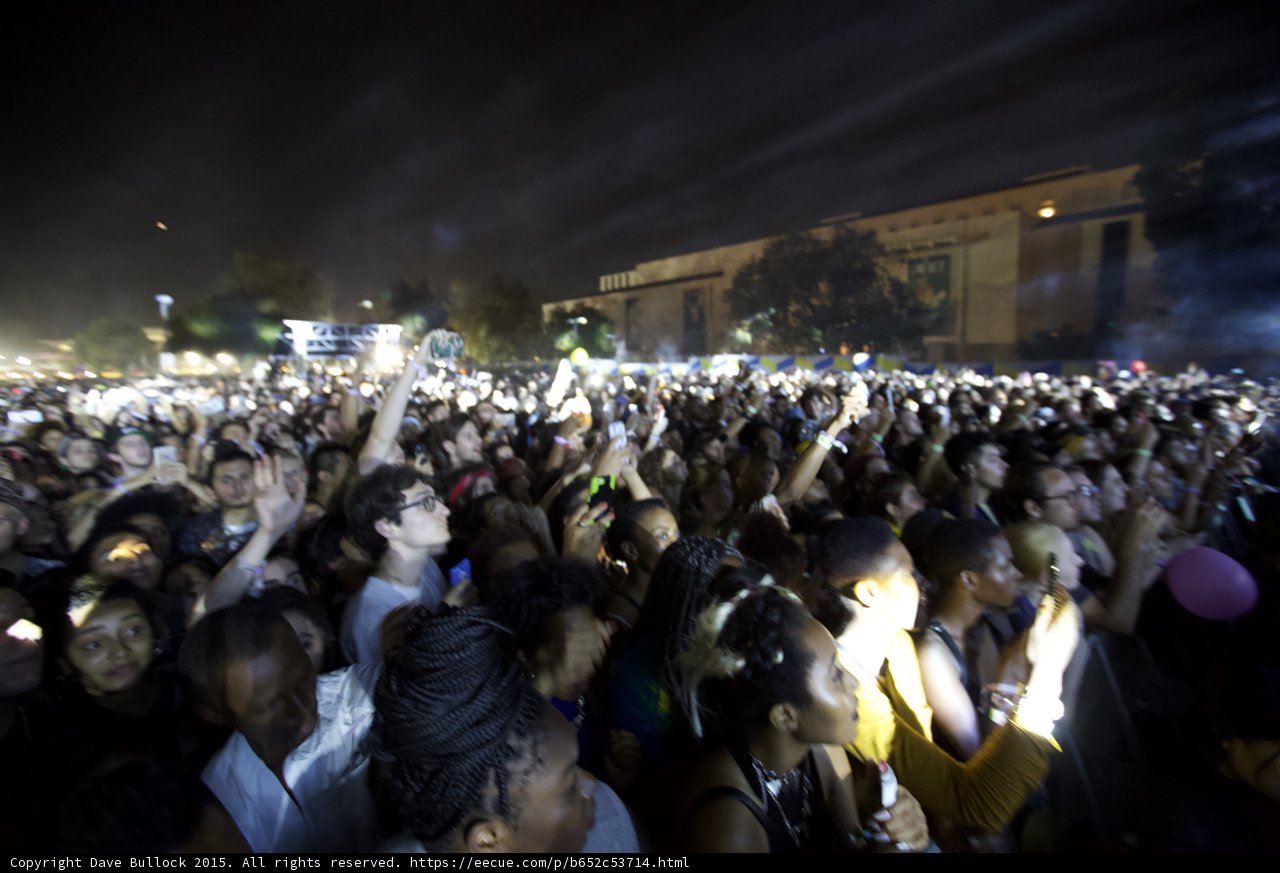 FYF Fest Large Crowd Night Phones Raised Yellow Shirt Purple Balloon Building Background