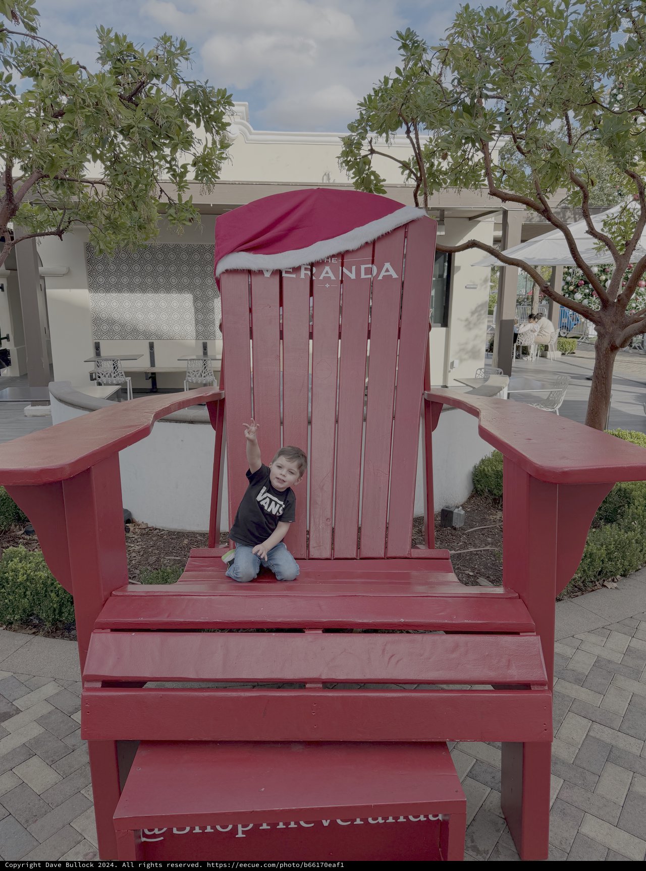 Child Playing on Giant Red Adirondack Chair