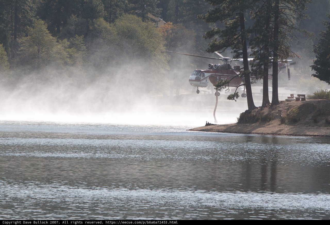 Helicopter Sprays Water on Lake to Fight Fire