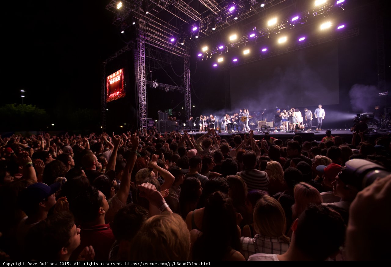 Belle and Sebastian Wide Stage Purple Magenta Lighting Arms Raised Stadium Lights Crowd Night