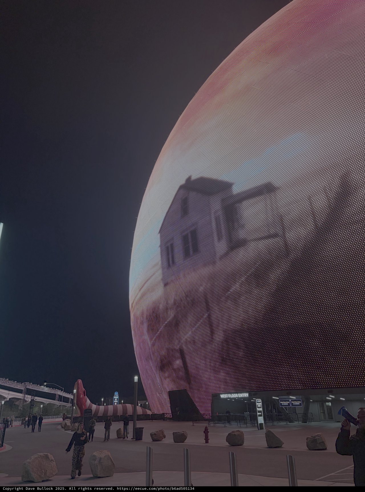 Futuristic Sphere Building with Digital Display at Night