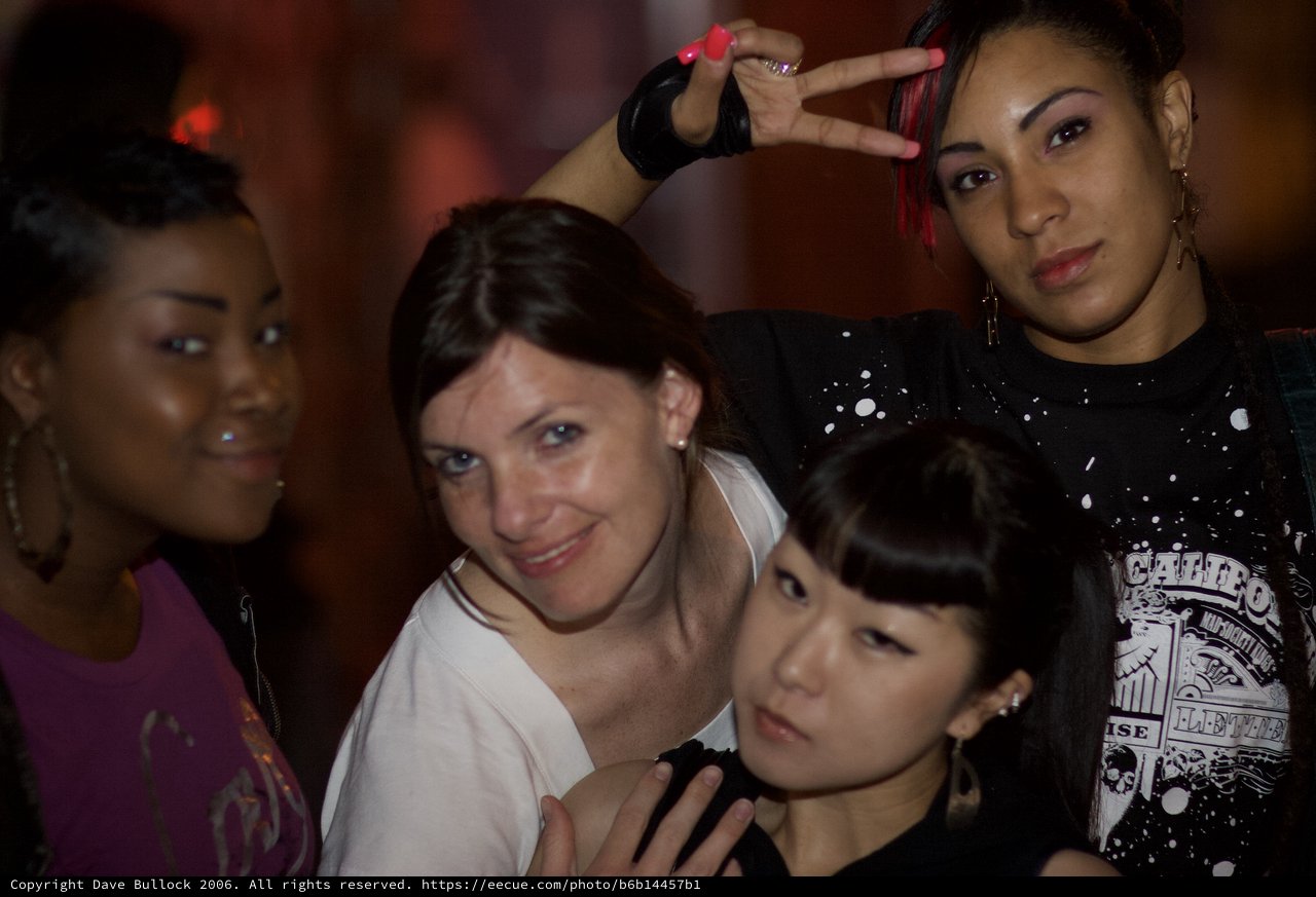 Four Women Posing Together at Nightclub Event