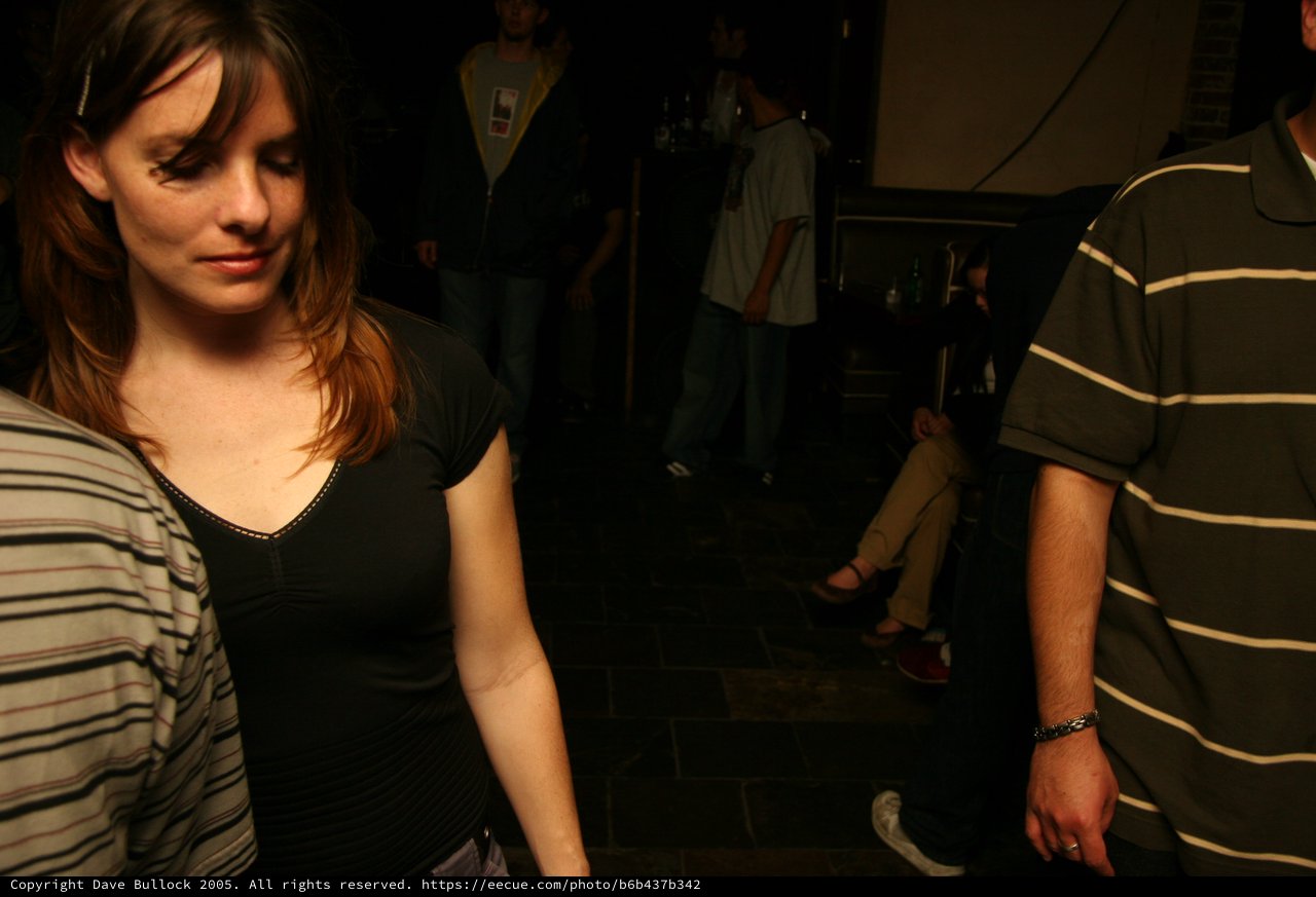 Young Woman at Dimly Lit Nightclub Event