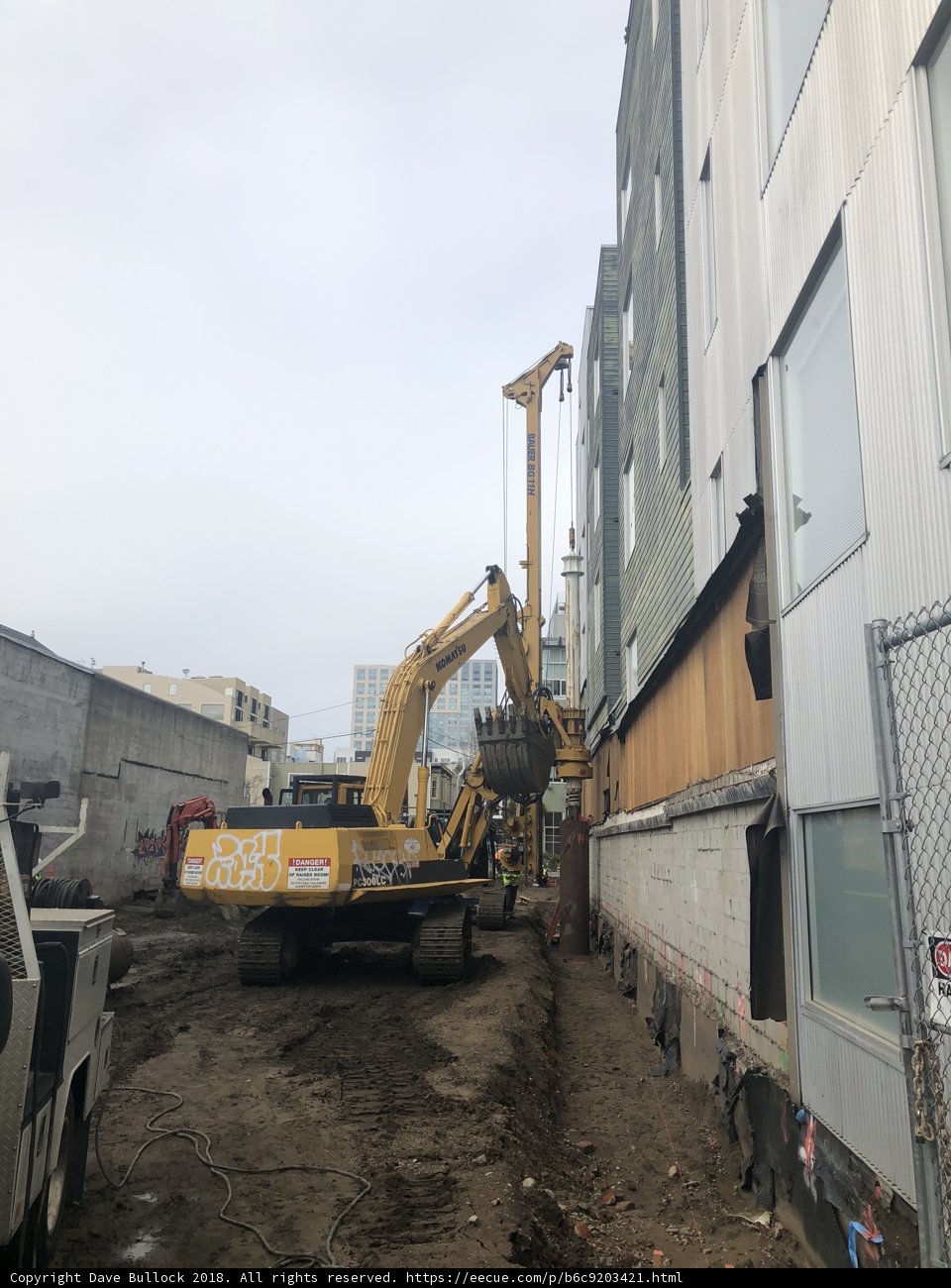 Construction Vehicle Parked Next to Building