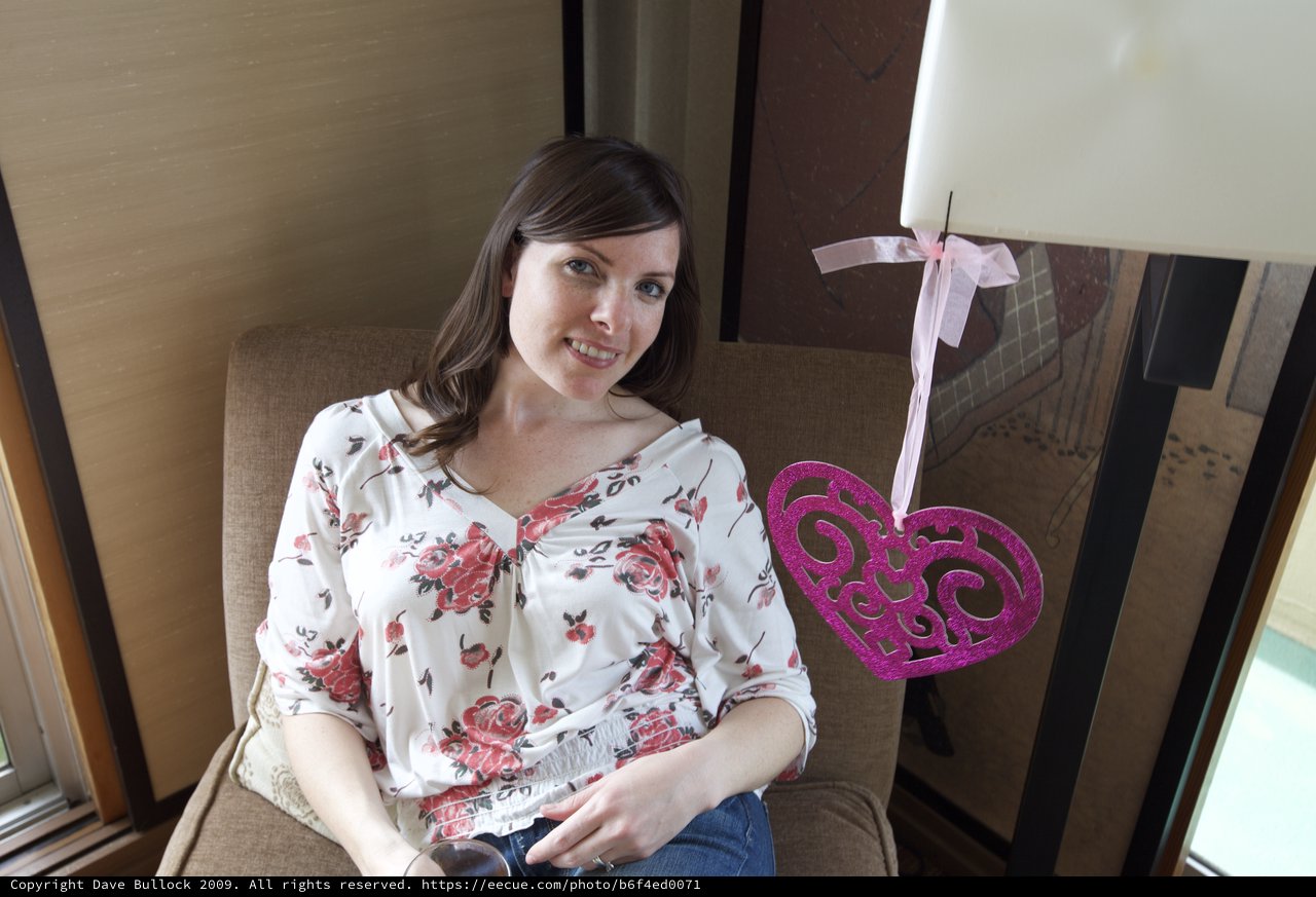 Woman Smiling with Valentine's Heart Decoration Indoors