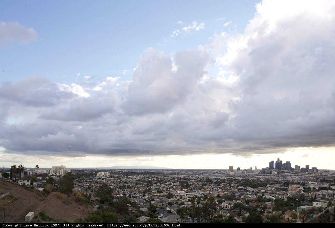 Majestic cumulus clouds over a bustling metropolis