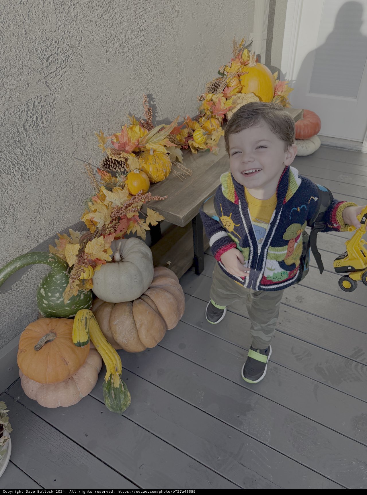 Child's Joyful Autumn Day with Fall Decorations