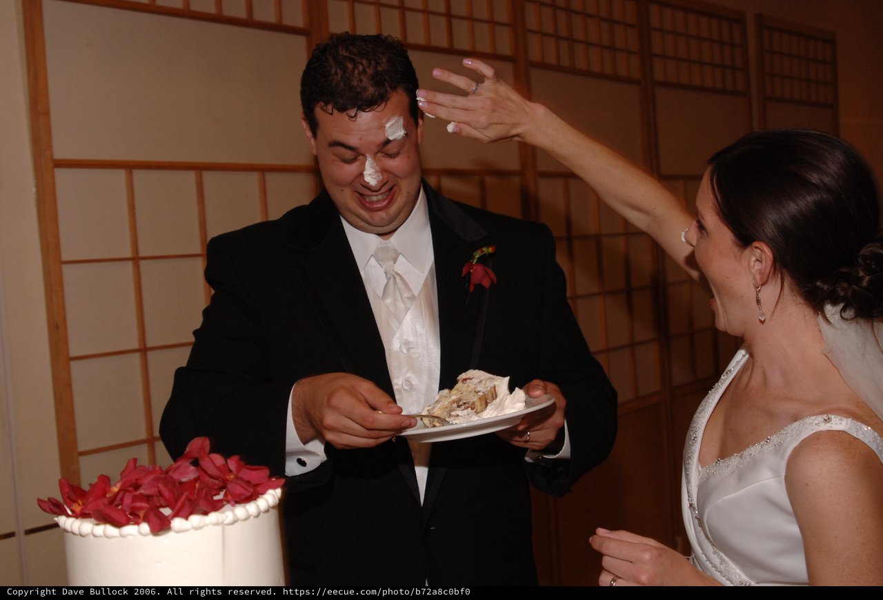 Bride Smashes Cake on Groom's Face at Wedding