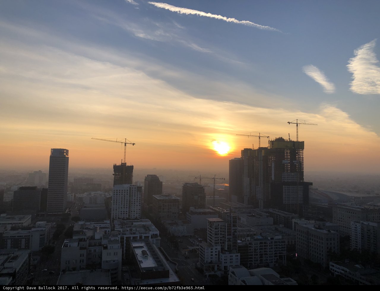 Urban Sunset with Construction Cranes