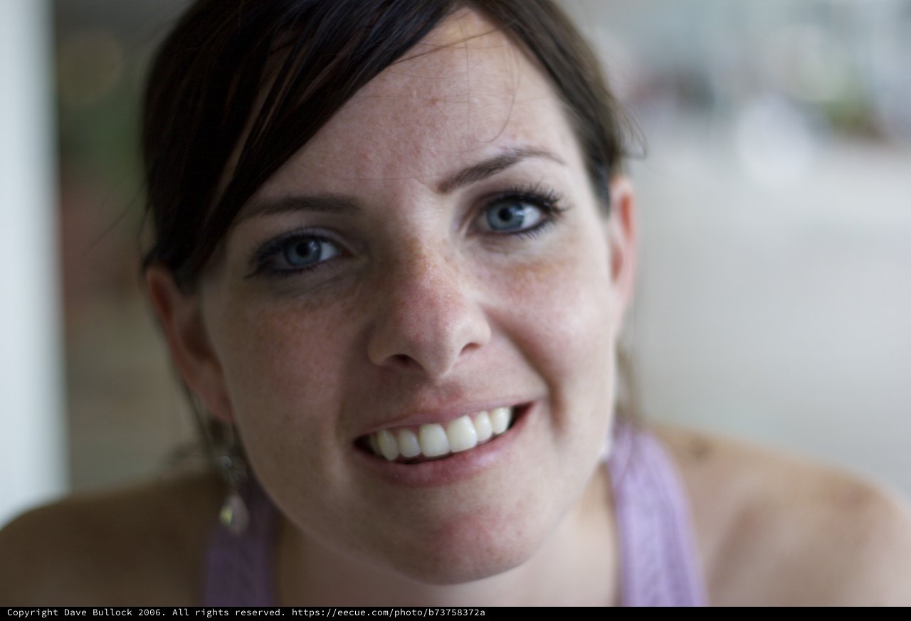 Freckled Woman with Blue Eyes Smiling Warmly