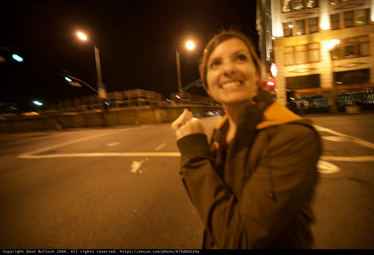 Joyful Woman Celebrating on City Streets at Night