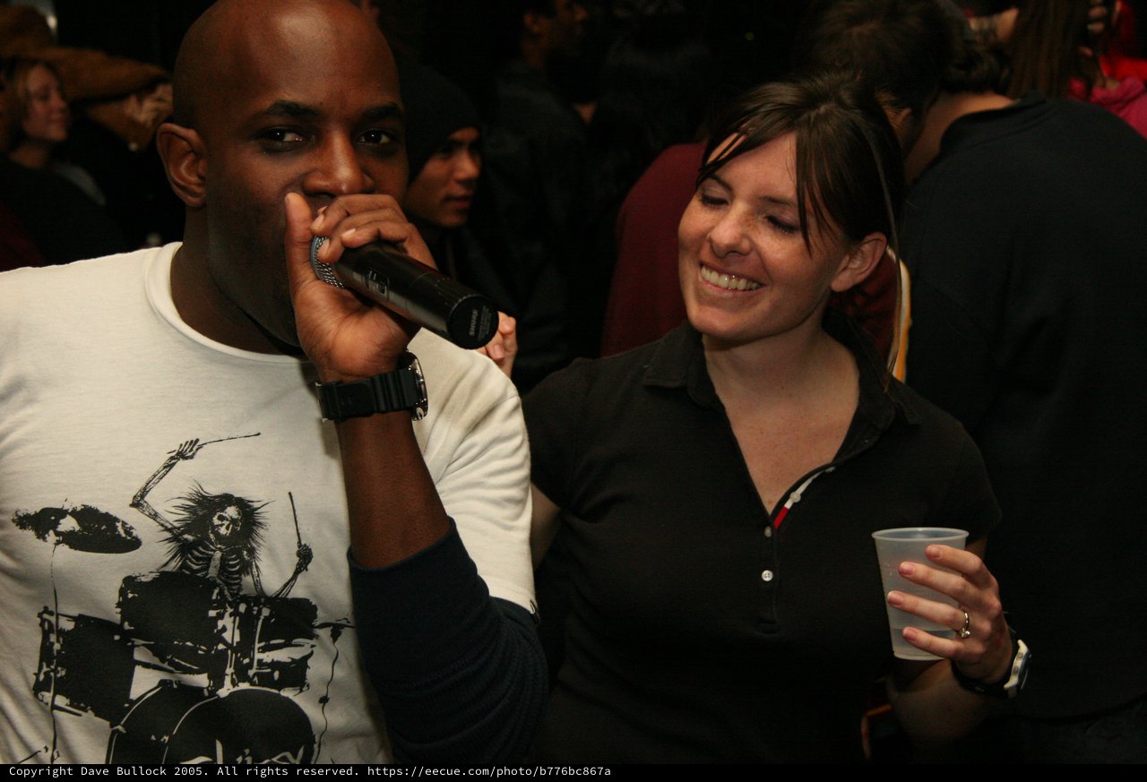 MC Q Performs at Lively Indoor Event with Crowd