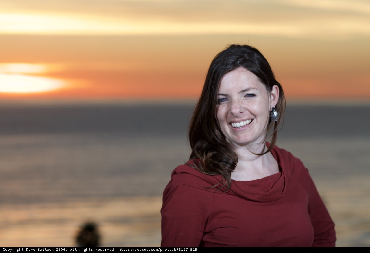 Smiling Woman at Golden Hour Seaside Sunset