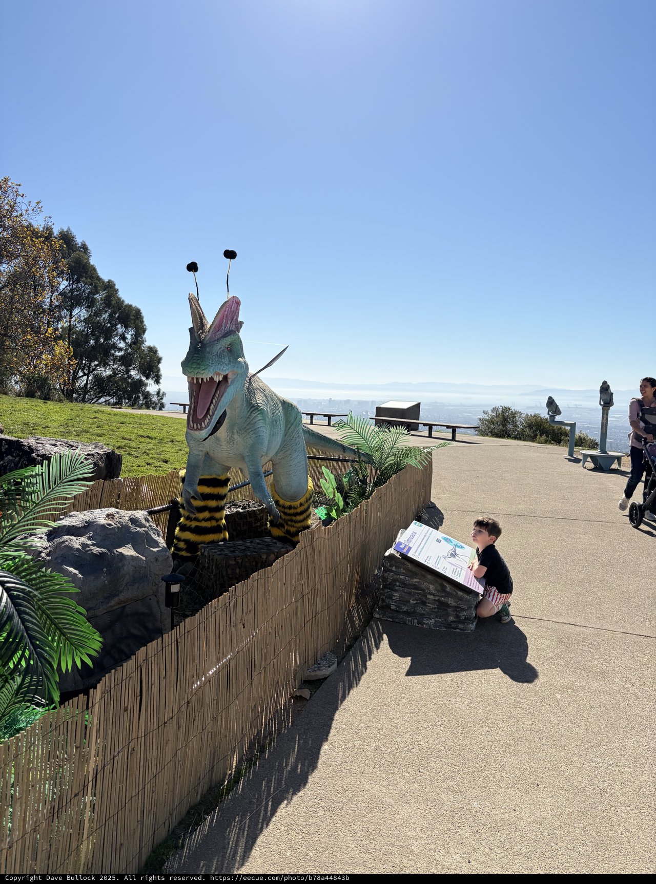 Whimsical Bee-Dinosaur Sculpture at Coastal Viewpoint