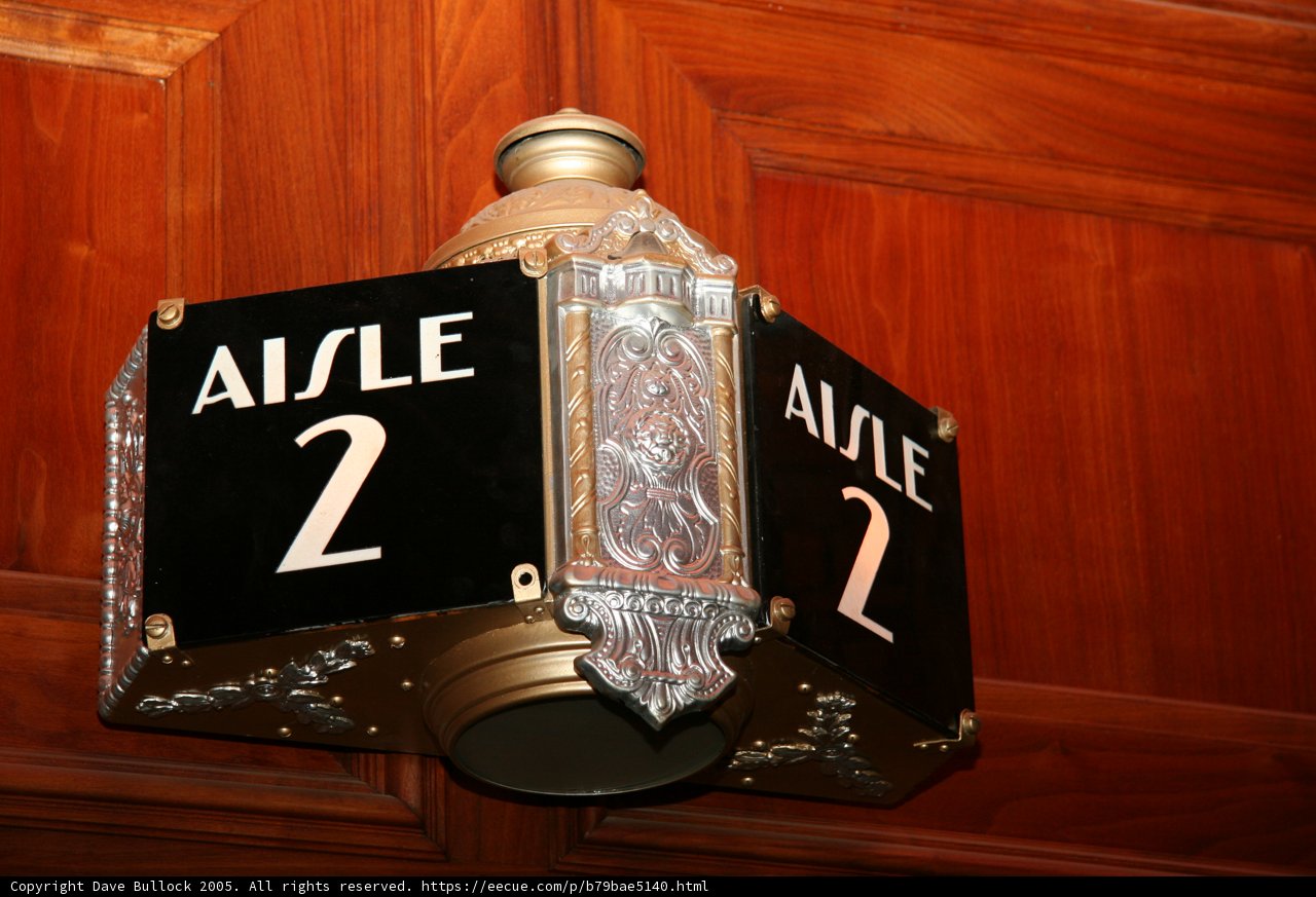Aile 2 Sign on Hardwood Wall
