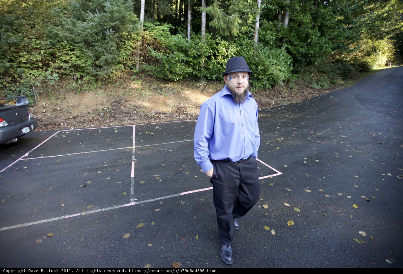 Man in Blue Standing in the Middle of the Road