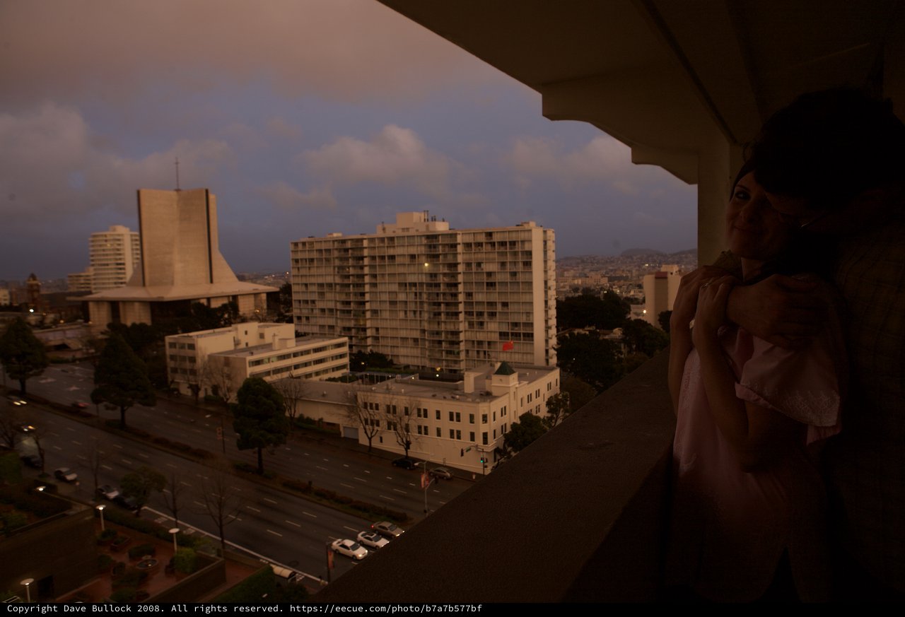 Woman on Hotel Balcony Overlooking San Francisco at Dusk