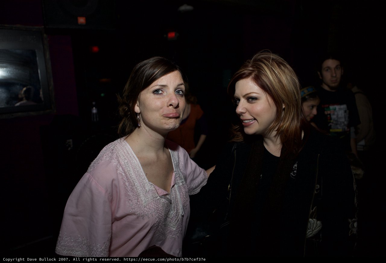 Two Women Sharing a Moment at Nightclub Event