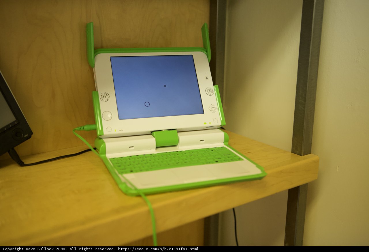 Green and White Laptop on Wooden Shelf