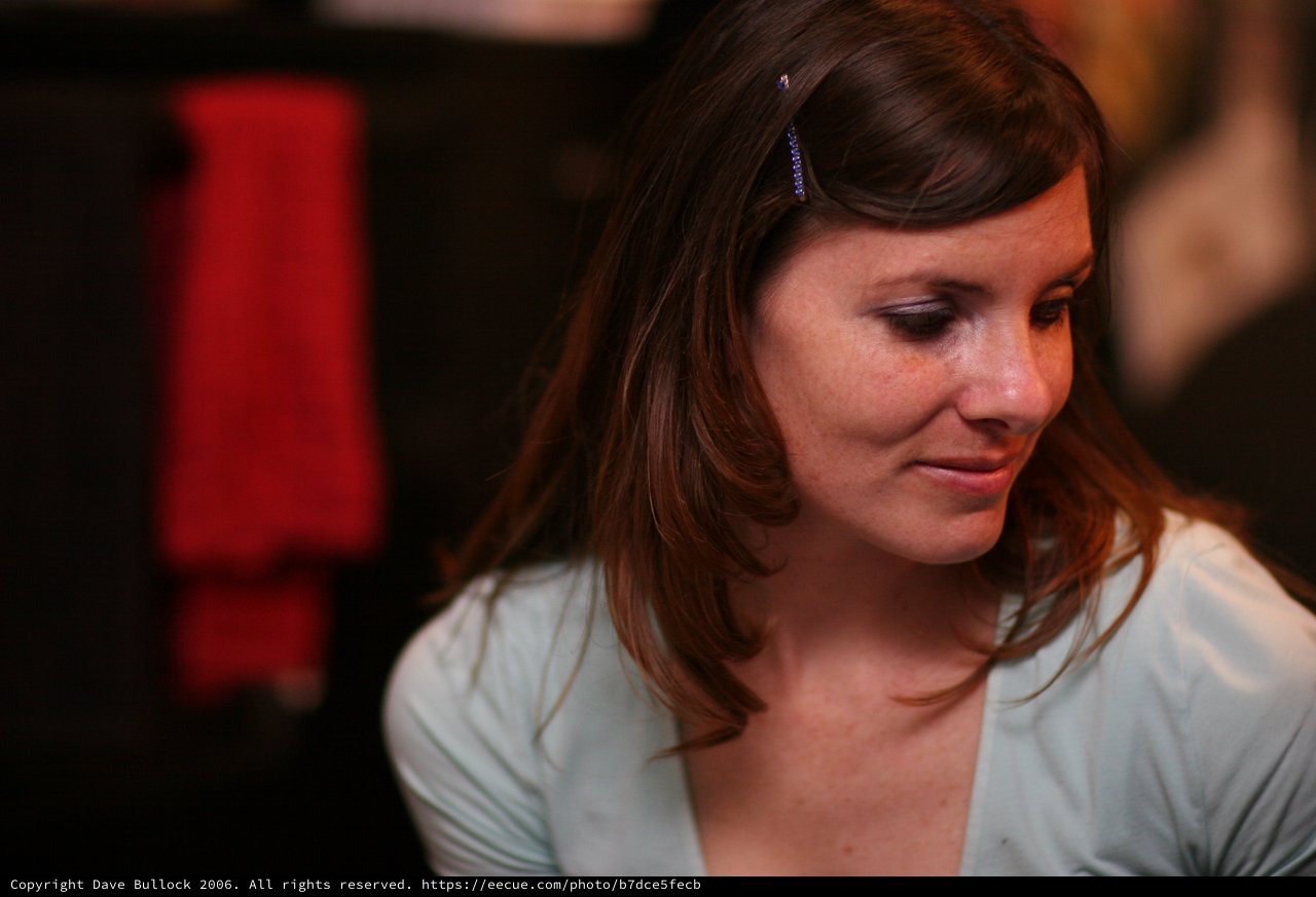 Thoughtful Woman in Soft Blue at Evening Event