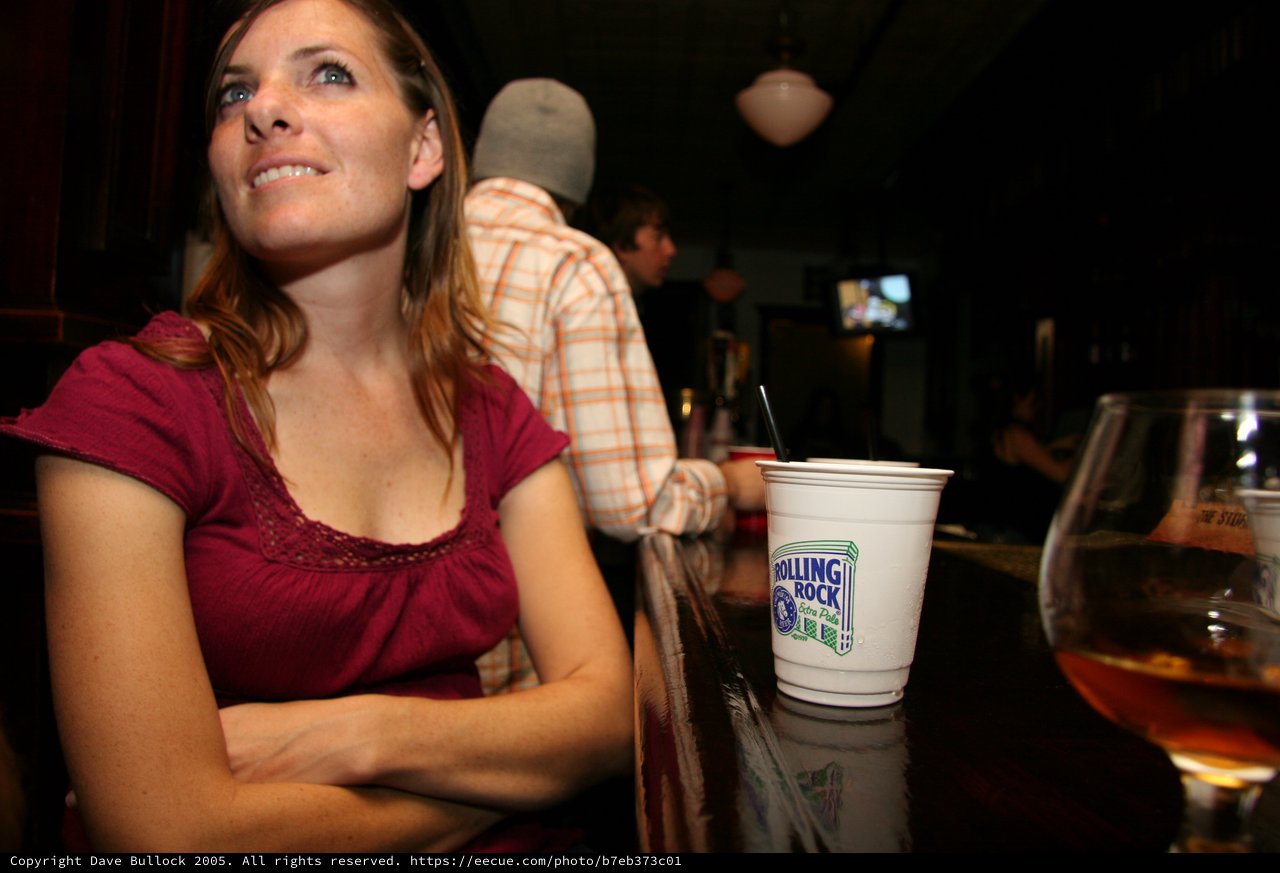 Woman at a Bar Watching Something Intently