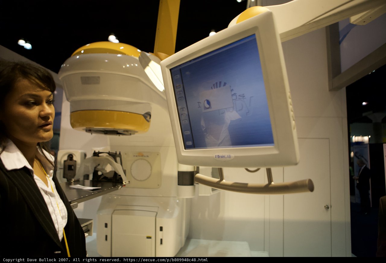 Woman Operating Large Machine in Hospital