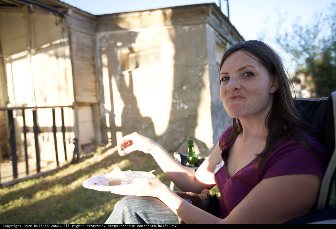 Woman Enjoying Outdoor Backyard Barbecue at Golden Hour