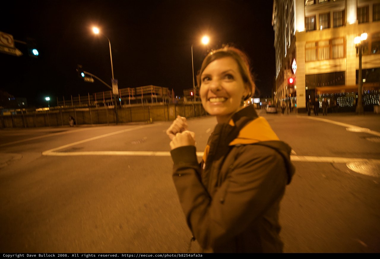 Joyful Woman Celebrating on City Streets at Night