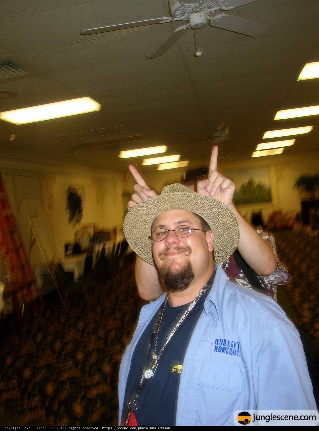 Two Men in Hats and Blue Shirts