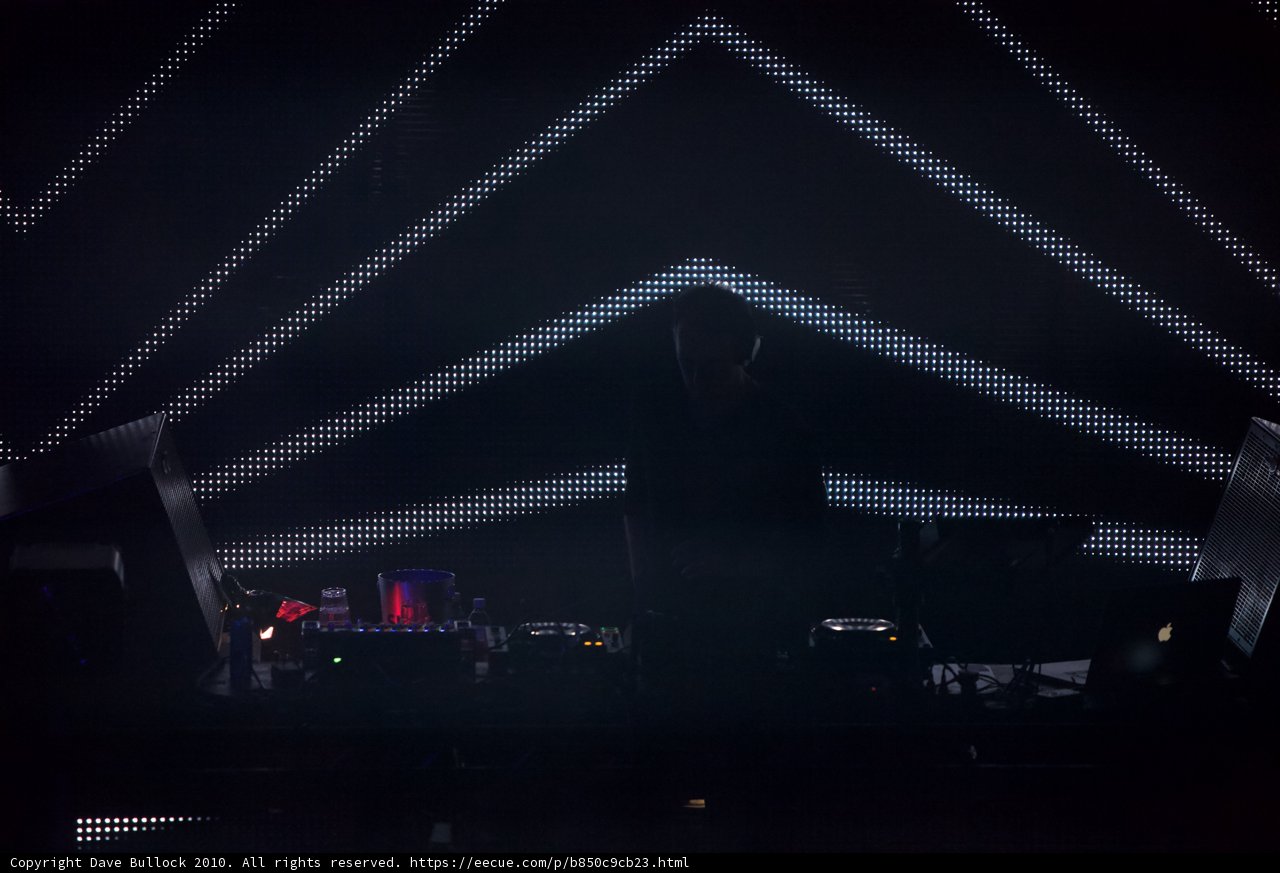 DJ plays music in front of giant screen at 2010 concert