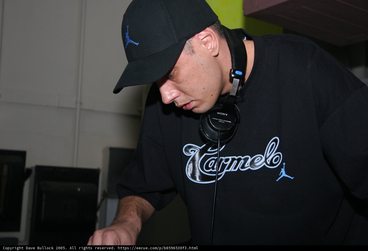 Black Shirted Man in a Baseball Cap and Headphones