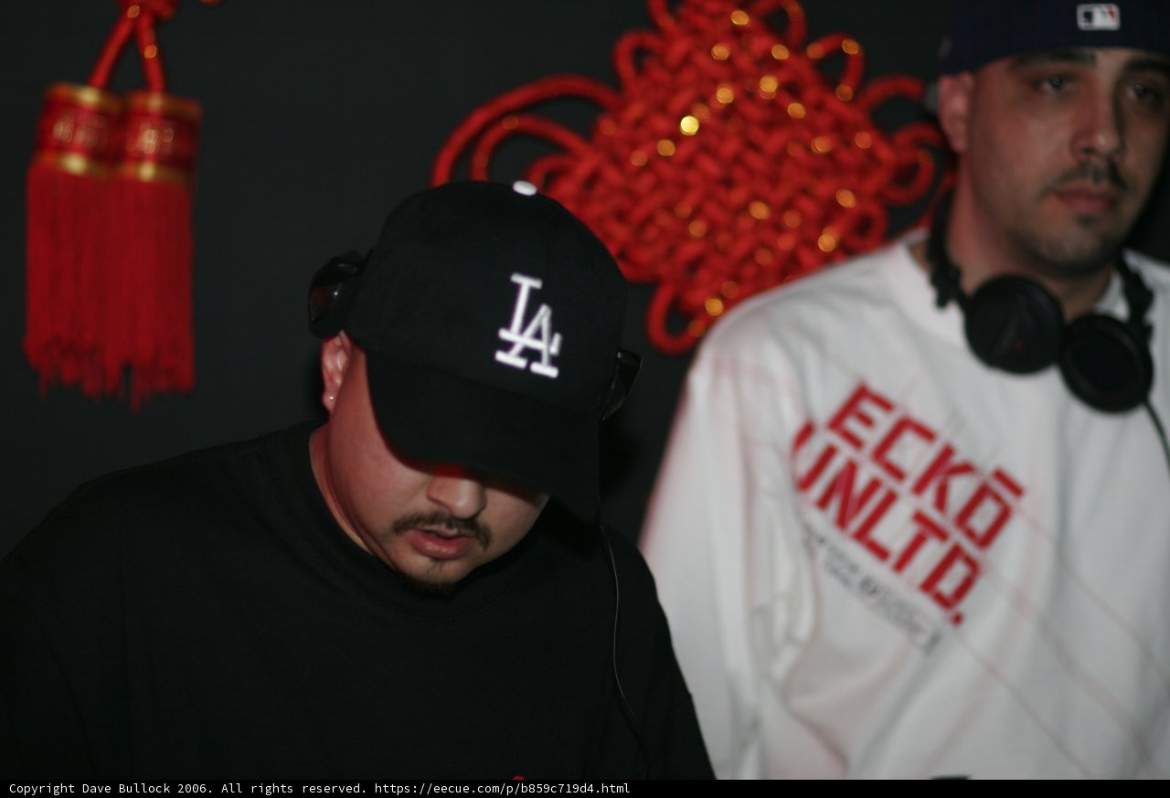 Two Men Sporting Caps and Headphones