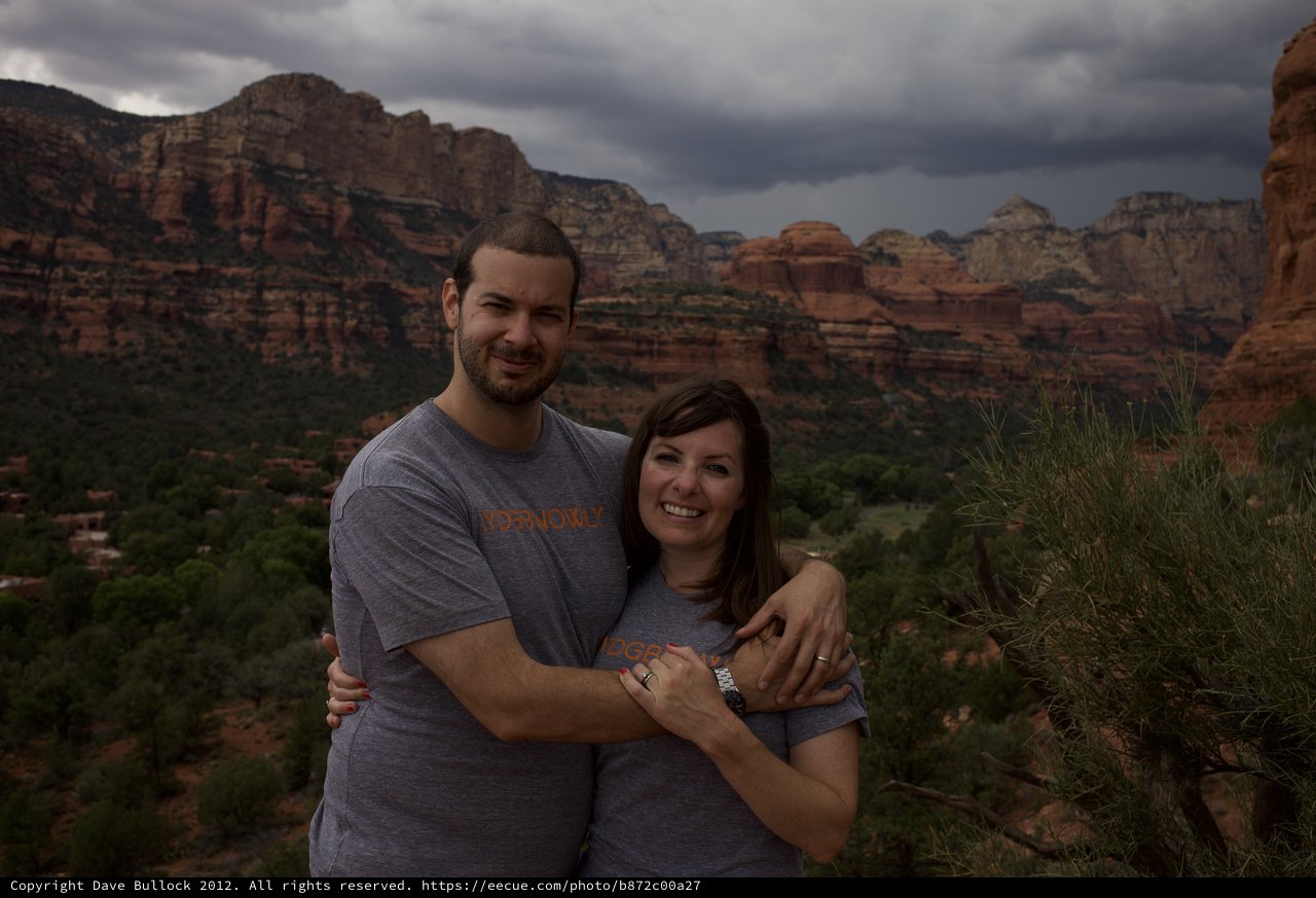 Couple Embracing Before Sedona's Dramatic Storm Skies