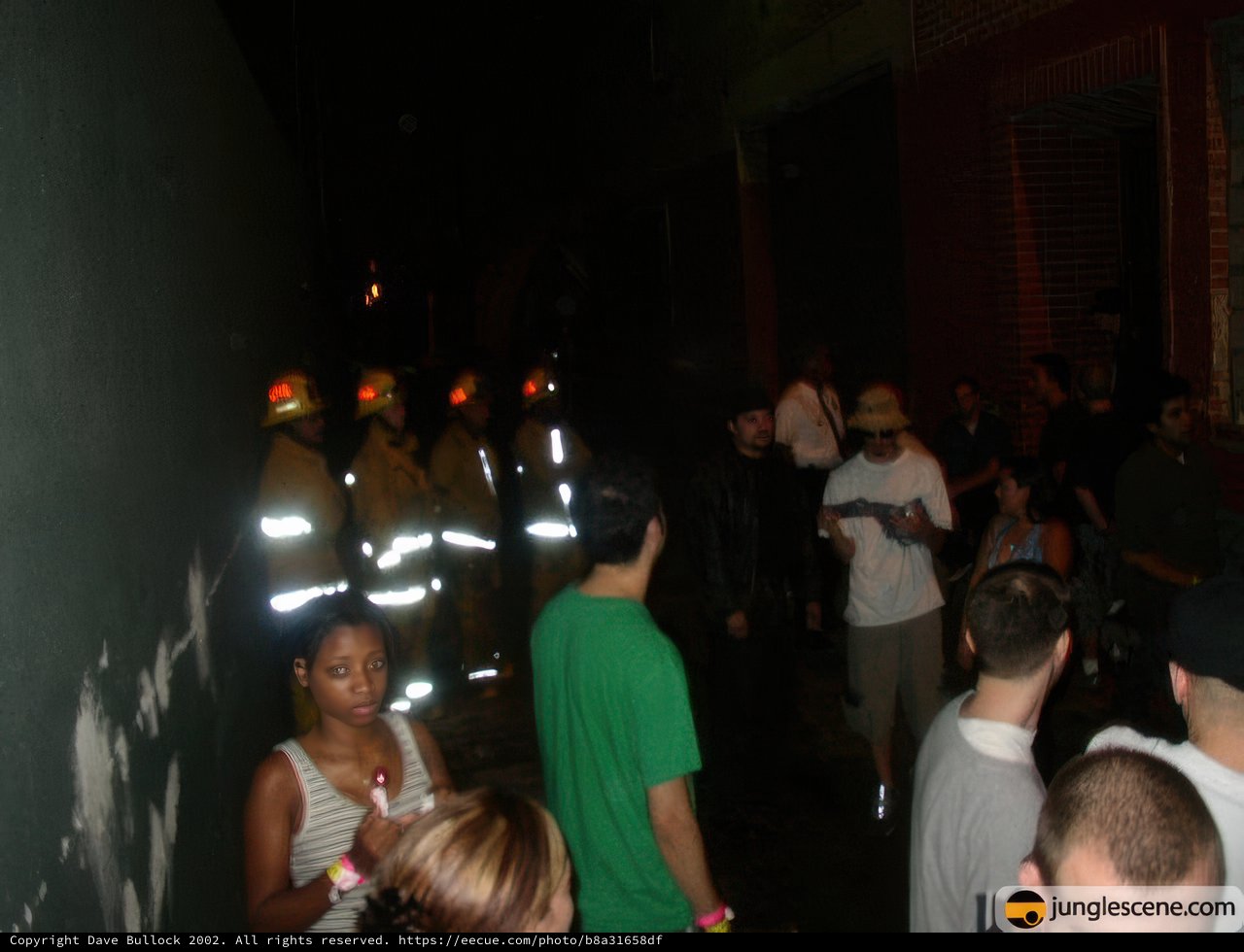 Urban Crowd Gathers in Front of Fire Truck