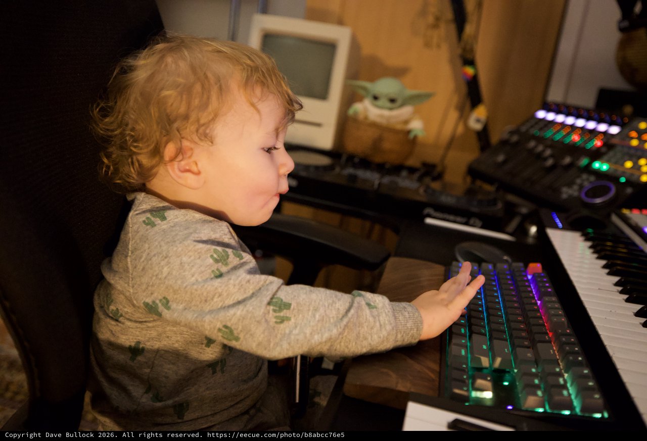 Young Child Exploring Music Production Equipment at Home