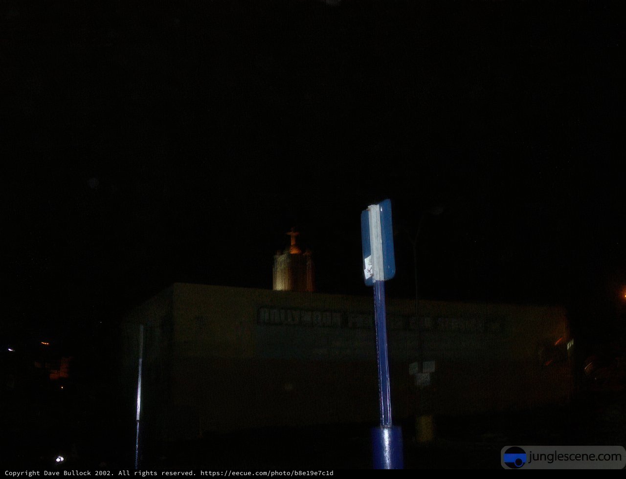 Nighttime Reflections: A Church and Street Sign