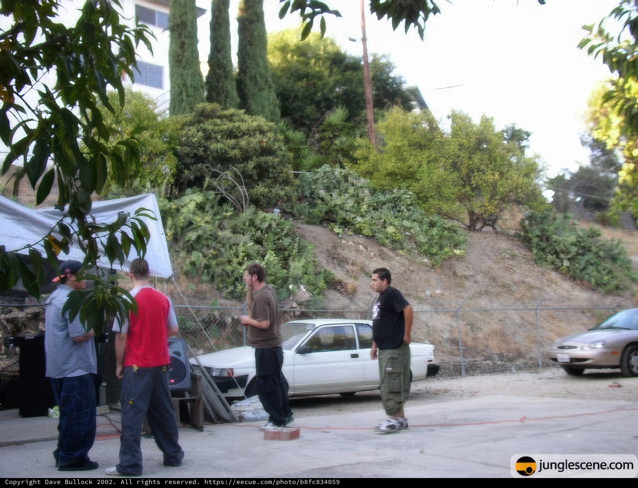 Group of Friends Gathered Around Cars