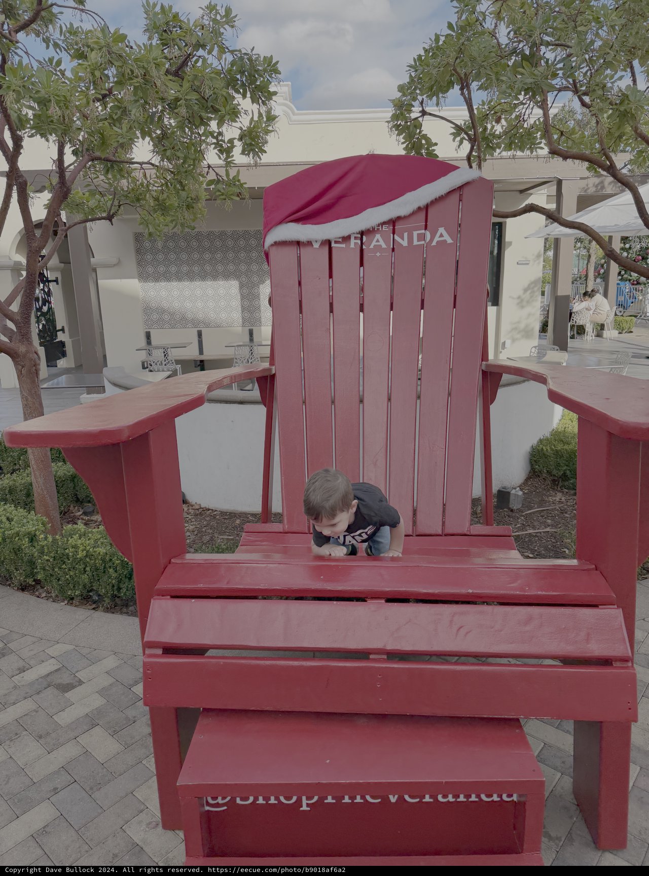 Child Playing on Giant Red Adirondack Chair