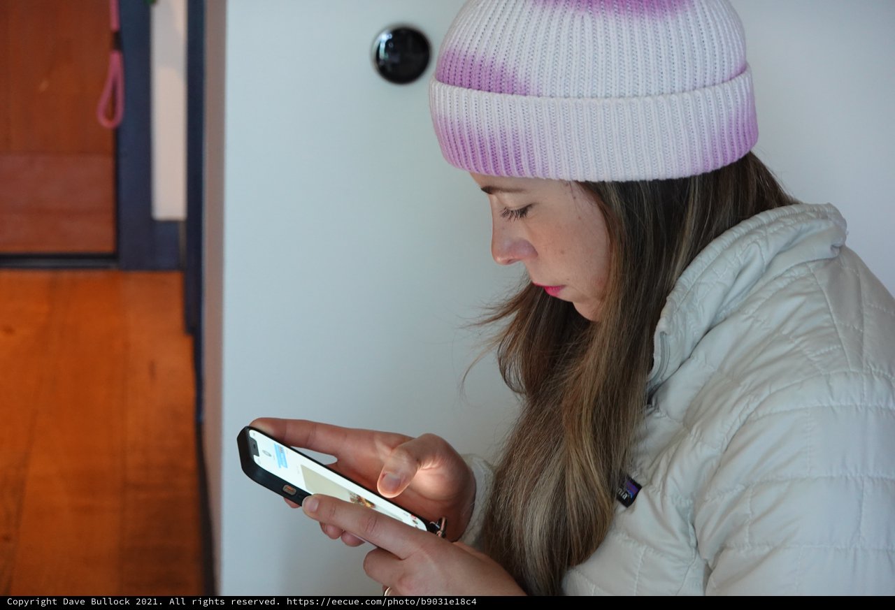 Young Woman Using Smartphone in Winter Coat