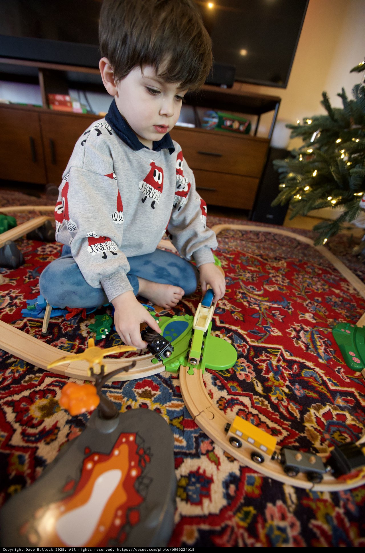 Young Boy Playing with Wooden Train Set on Christmas