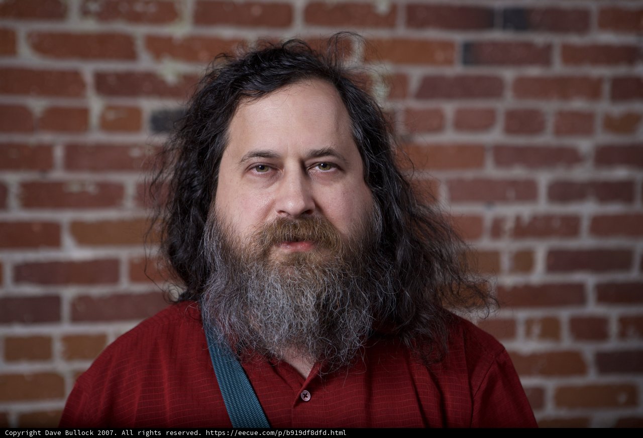 Richard Stallman Poses in Front of Brick Wall