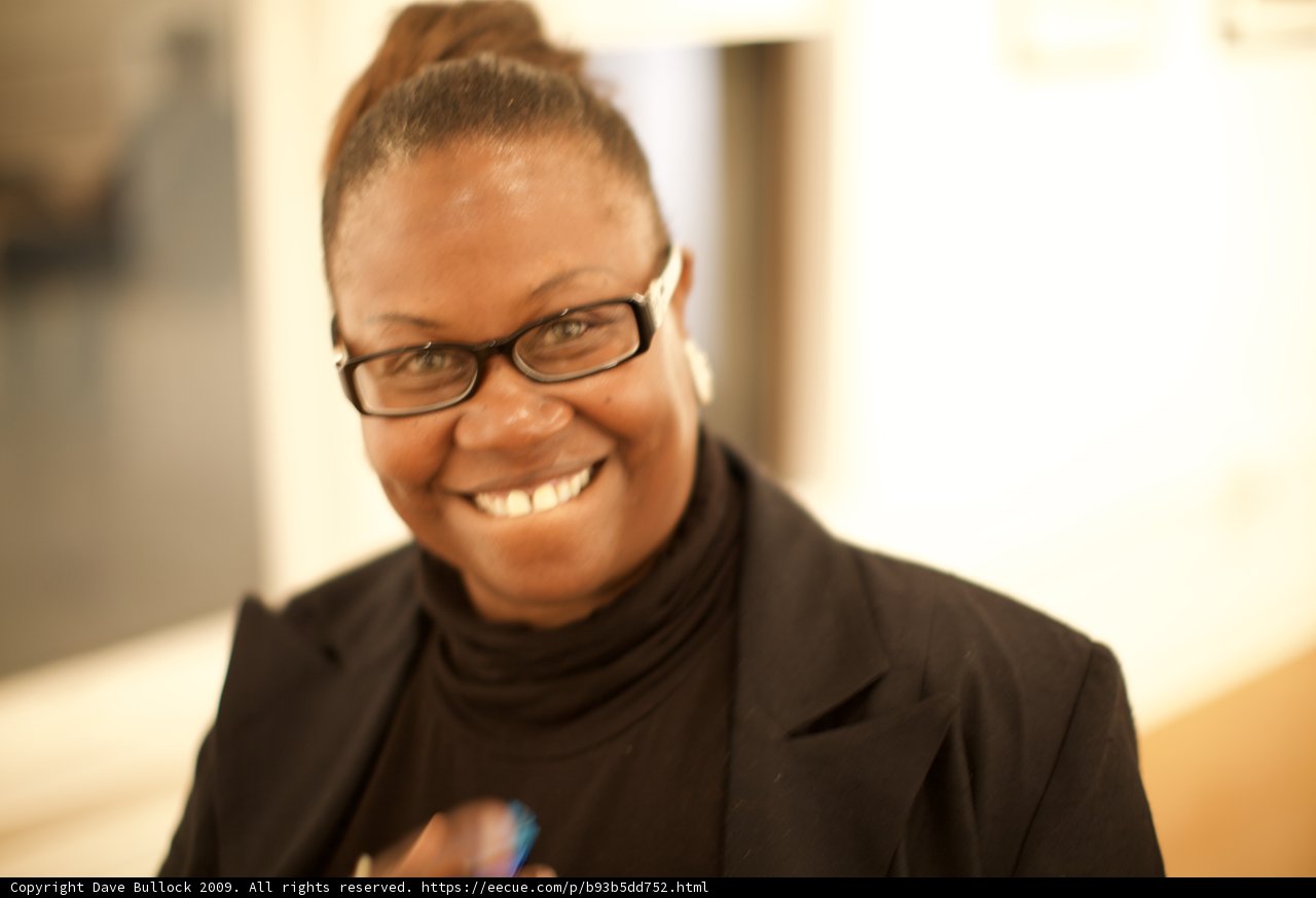 Smiling Woman in Black Shirt and Glasses