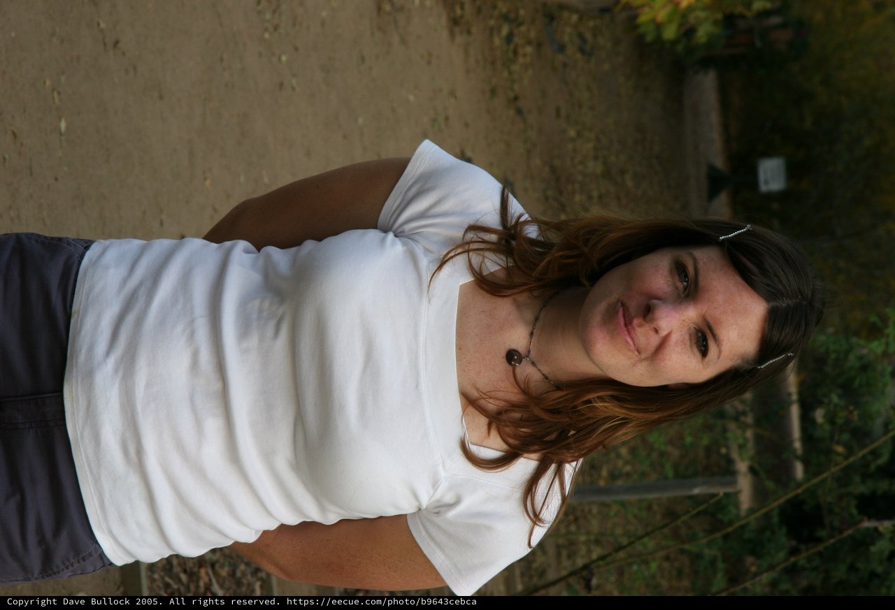 Smiling Woman on a Wooded Park Pathway