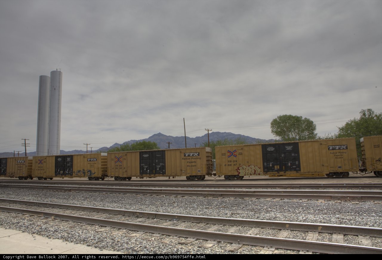 Freight Train Traveling Through Majestic Mountain Range