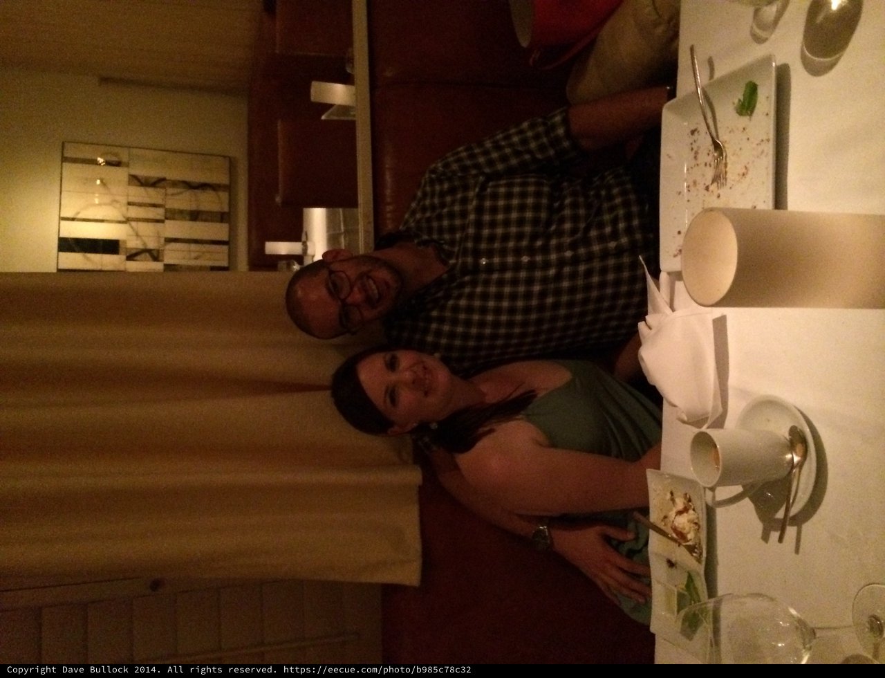 Couple Smiling Together at Romantic Restaurant Dinner